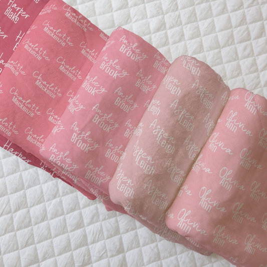 Assorted pink baby blankets with various names in script, luxurious and soft for delicate skin.