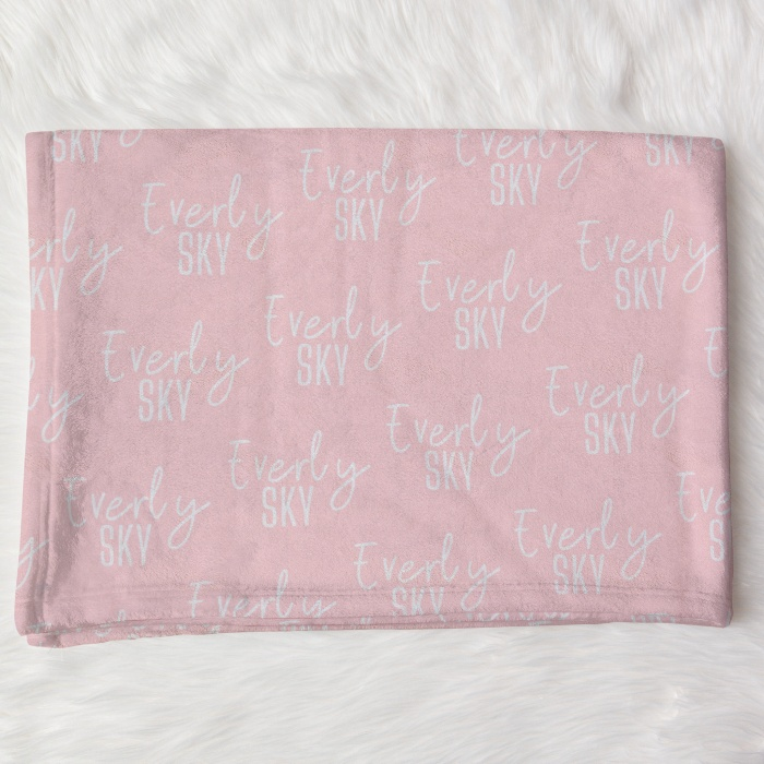 Customized pink baby blankets with 'Everly SKY' name pattern, soft fabric for newborn comfort.