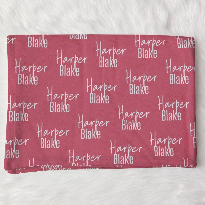 Personalized deep pink baby blanket with 'Harper Blake' in white script, cozy for infant snuggles.