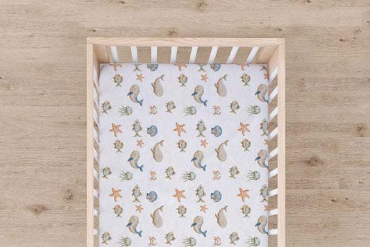 Wrap your little one in the cozy embrace of the Ocean Breeze Jersey Fitted Crib Sheet, designed to offer the ultimate comfort and warmth, reminiscent of your favorit