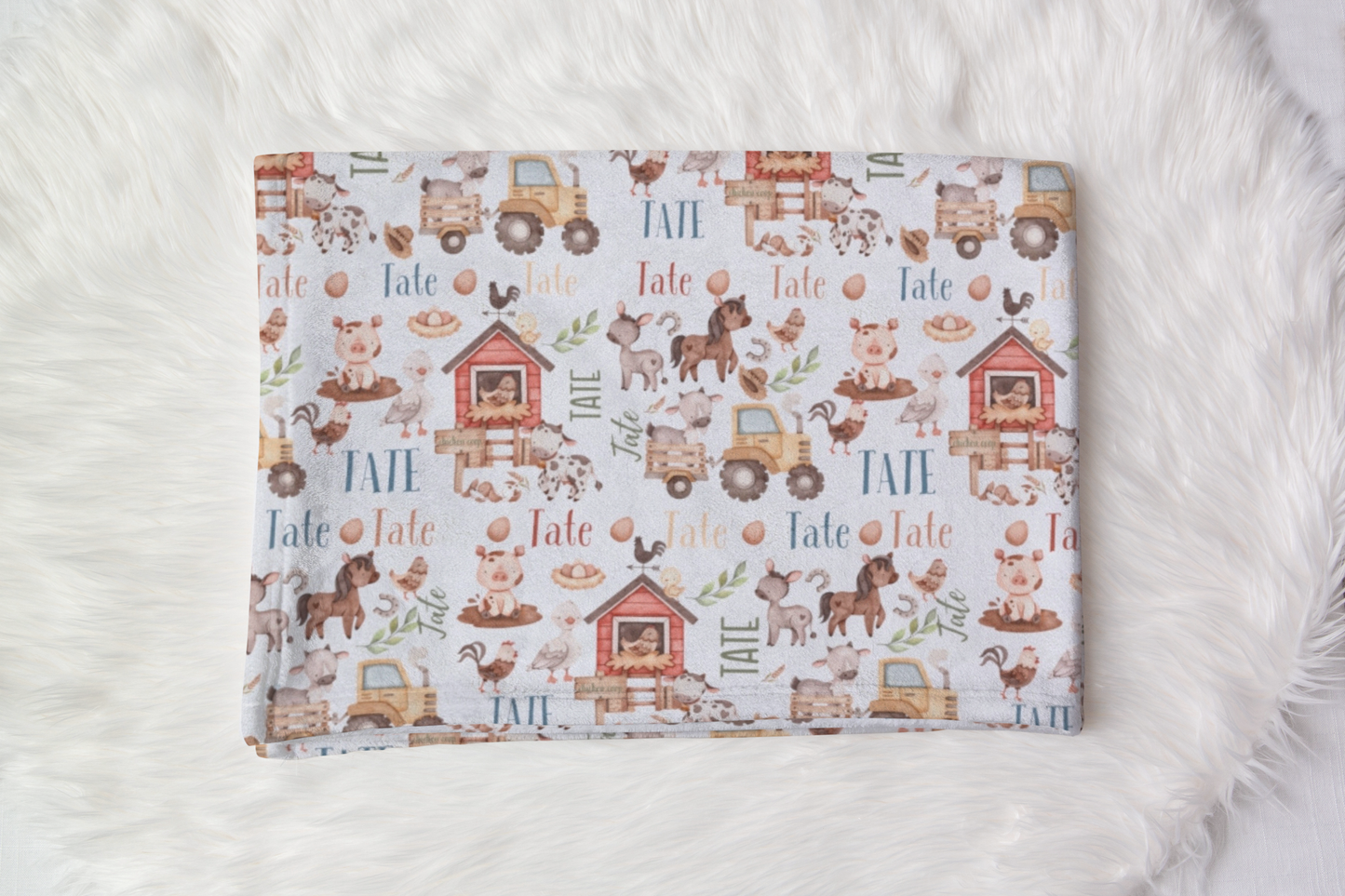 Personalized farm animal baby blanket, with the option to customize with a child's name amidst whimsical farm scenes, ideal for cuddling.