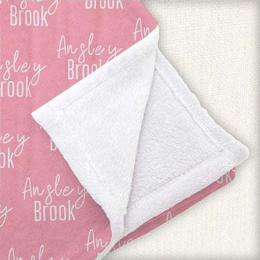 Soft pink baby blanket folded, showcasing custom 'Everly SKY' text, perfect for baby girl gifting.